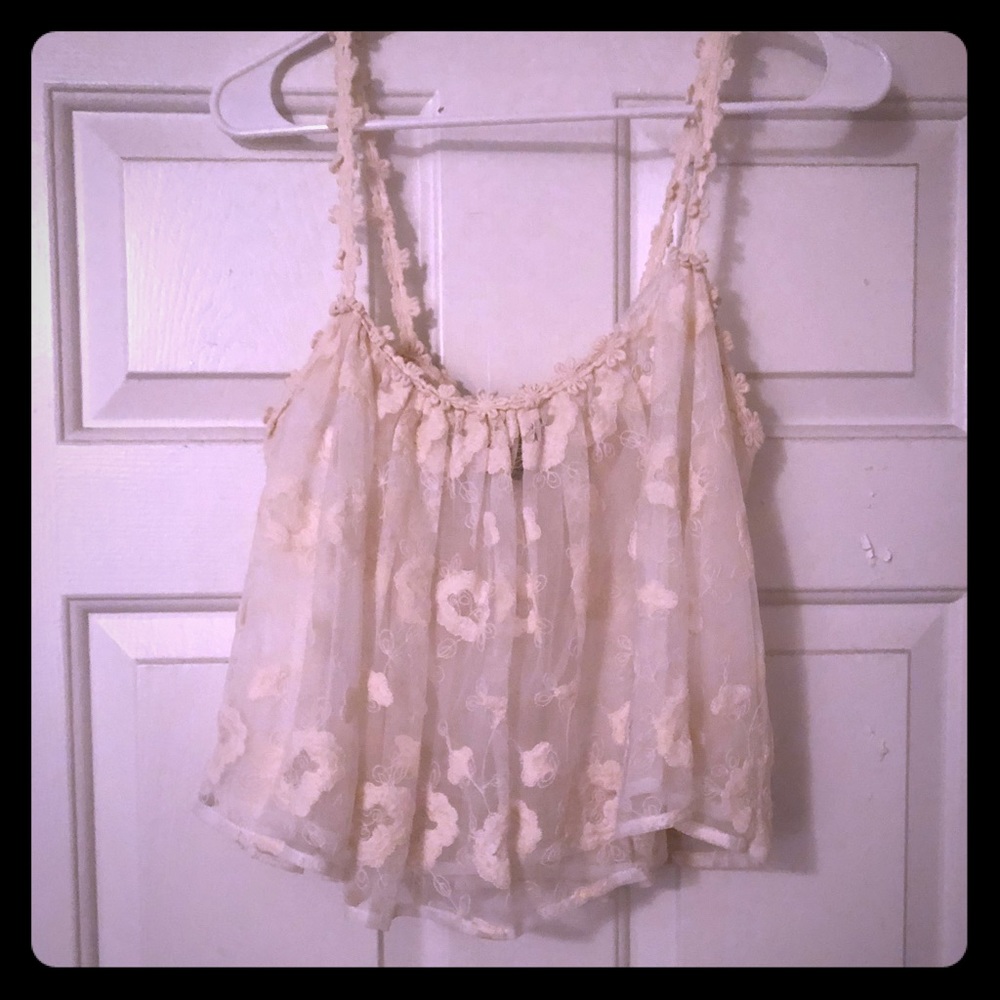 A flouncy, double layered off-white tank blouse